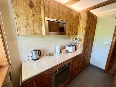 a kitchen with a counter with a coffee maker on it at Villa Anna apartment - Center view - in Cortina dʼAmpezzo