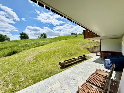 a house with a view of a large field at Villa Anna apartment - Center view - in Cortina dʼAmpezzo