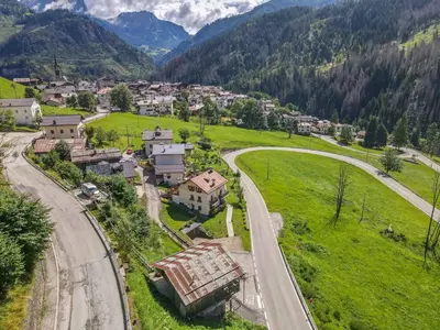 an aerial view of a village in the mountains at Tabia Sasso Bianco in Rocca Pietore