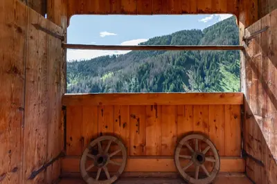 a window in a wooden cabin with a mountain view at Tabia Sasso Bianco in Rocca Pietore