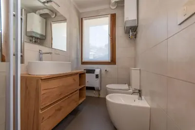 a bathroom with a sink and a toilet at Casa dei Gigli in Selva di Cadore