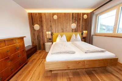 a bedroom with a large bed and a window at Biohof Oberwerkstatt HAIDI in Obereggen