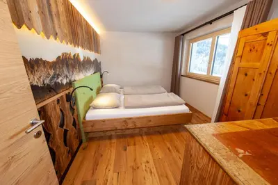a small bedroom with a bed in the corner at Biohof Oberwerkstatt HAIDI in Obereggen