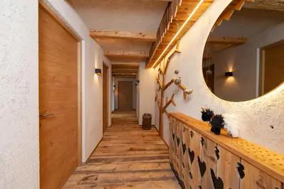 a hallway in a house with a mirror on the wall at Biohof Oberwerkstatt HAIDI in Obereggen