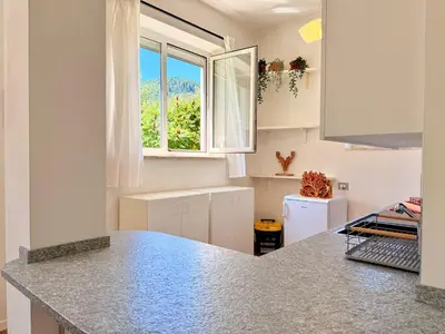 a kitchen with a counter top and a window at Alberi di Fiemme in Castello di Fiemme