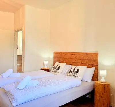 a bedroom with a large bed with two lamps at Alberi di Fiemme in Castello di Fiemme