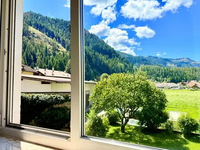 a window with a view of a mountain at Alberi di Fiemme in Castello di Fiemme