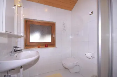 a bathroom with a sink and a toilet and a window at Apartments Gasserhof in Lagundo
