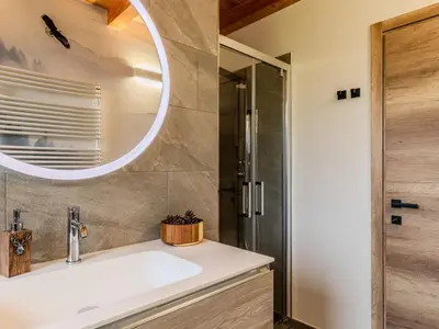 a bathroom with a sink and a mirror at Apartment Larice Quadrilocale by Interhome in Livo