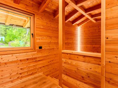 a wooden sauna with a window in a log cabin at Apartment Larice Quadrilocale by Interhome in Livo