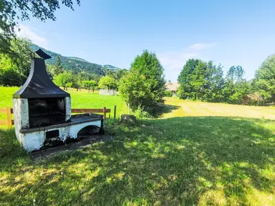 an old stove in the middle of a field at Chalet Altavista by Interhome in Ziano di Fiemme