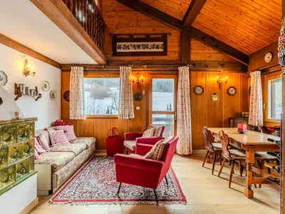 a living room with a couch and a table at Chalet Altavista by Interhome in Ziano di Fiemme