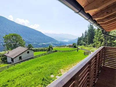 a view from the balcony of a house with a green field at Apartment Larice Bilocale by Interhome in Livo