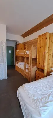 a bedroom with two bunk beds in a room at La Tana della Volpe, Falcade - BL in Falcade