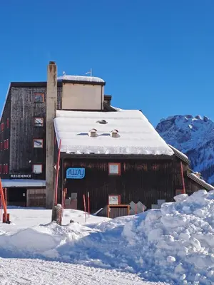 a building with snow on the roof of it at La Tana della Volpe, Falcade - BL in Falcade