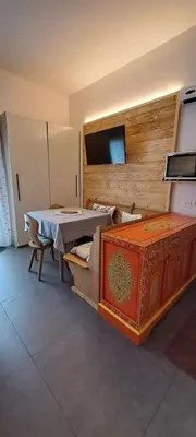 a living room with a table and a couch at La Tana della Volpe, Falcade - BL in Falcade