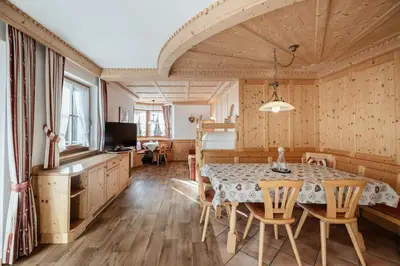 a kitchen and dining room with a table and chairs at Chalet Bel Plan in Ortisei