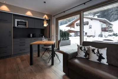 a living room with a couch and a table at Chalet Bel Plan in Ortisei