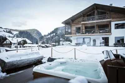 a jacuzzi tub on a snow covered mountain at Chalet Bel Plan in Ortisei