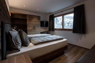 a bedroom with a large bed with a window at Chalet Bel Plan in Ortisei