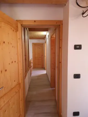 a hallway in a house with wooden walls and floors at Cesa Pegghy in Canazei