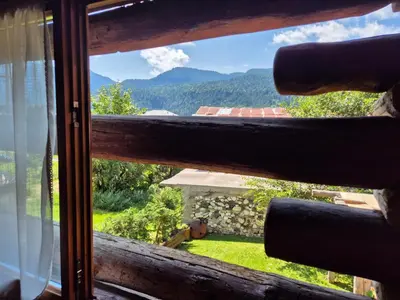 a window with a view of a mountain at Antico Fienile in Borca di Cadore