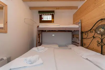 two bunk beds in a room with wooden walls at Suite Anna in Masarè
