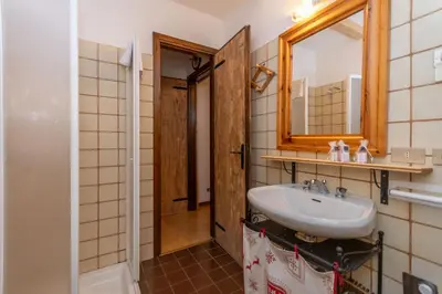 a bathroom with a sink and a mirror at Suite Anna in Masarè