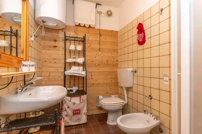 a bathroom with a toilet and a sink at Suite Anna in Masarè