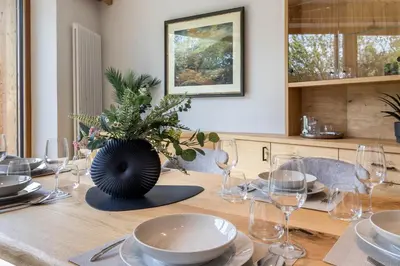 a wooden table with glasses and a vase on it at Haus Lupwald in Falzes