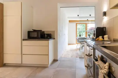 a kitchen with white cabinets and a microwave at Haus Lupwald in Falzes