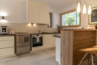 a kitchen with stainless steel appliances and a window at Haus Lupwald in Falzes