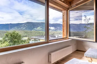 a room with windows with a view of mountains at Haus Lupwald in Falzes