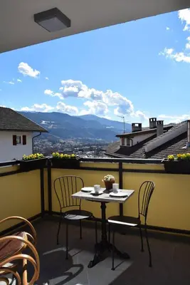 a table and chairs on a balcony with a view at Casa di Maria Grazia in Bressanone