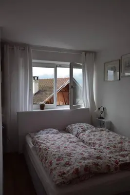 a bedroom with a bed in front of a window at Casa di Maria Grazia in Bressanone