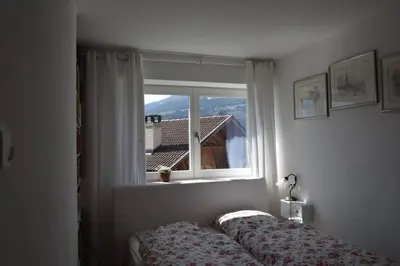 a bedroom with a bed and a window at Casa di Maria Grazia in Bressanone