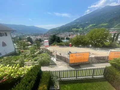 a view of a city with mountains in the background at Casa di Maria Grazia in Bressanone