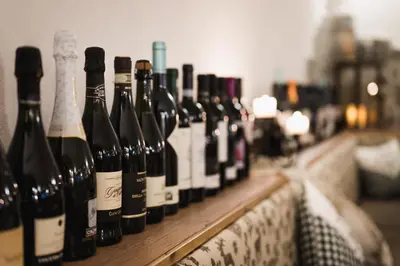 a row of bottles of wine sitting on a table at Laguscei Dolomites Mountain Hotel in Arabba