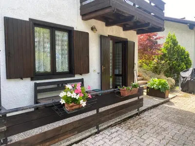 a house with two potted plants on the front porch at EmilyNest in Vervò