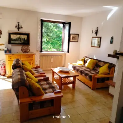 a living room with two couches and a table at EmilyNest in Vervò