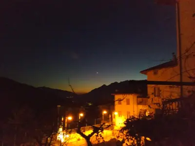 a night view of a building with street lights at EmilyNest in Vervò