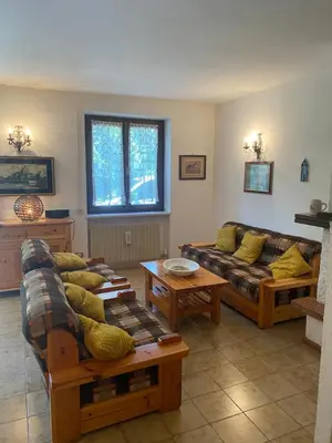 a living room with couches and a couch and tables at EmilyNest in Vervò