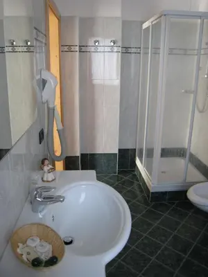a bedroom with a bed and a desk and a table at Garni B&B Mozart Nesthouse in Canazei