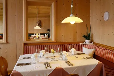a dining room with a table in a restaurant at Hotel Schön Aussicht in Schenna
