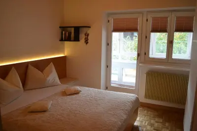 a bedroom with a bed with two pillows on it at Ferienwohnung Pramstaller in Valdaora
