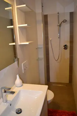 a bathroom with a sink and a shower at Ferienwohnung Pramstaller in Valdaora