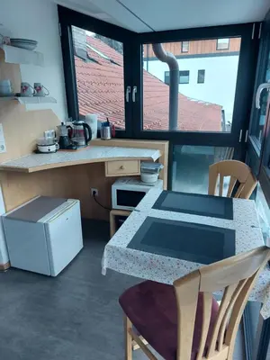a kitchen with a table and chairs and a counter at Ferienwohnung Pramstaller in Valdaora