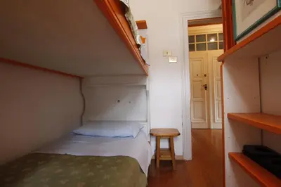 a small bedroom with a bed and a table at Casa in Centro di Cortina D'Ampezzo in Cortina dʼAmpezzo
