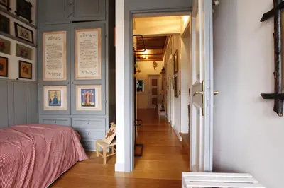 a bedroom with a pink bed and a hallway at Casa in Centro di Cortina D'Ampezzo in Cortina dʼAmpezzo