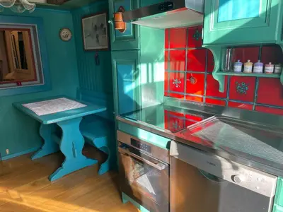 a kitchen with a toy stove and a table at Casa in Centro di Cortina D'Ampezzo in Cortina dʼAmpezzo